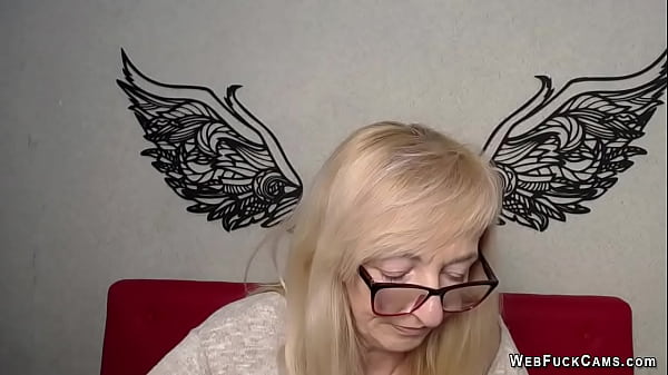 Blonde MILF with glasses performs on webcam clothed